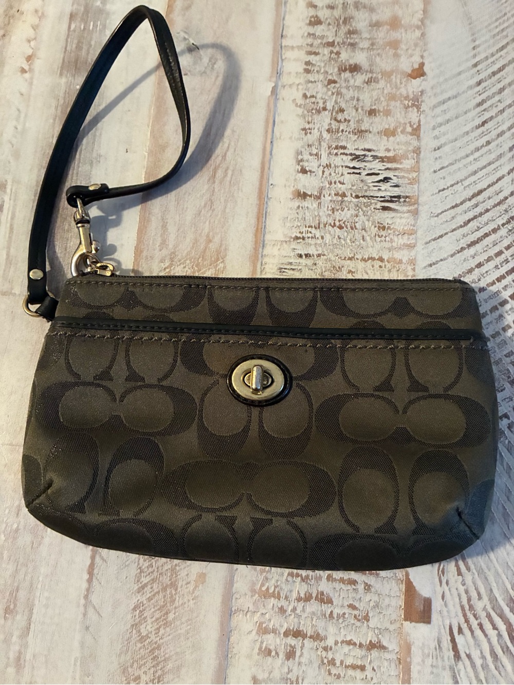 Coach signature jacquard wristlet gold-tone turnlock closure. 